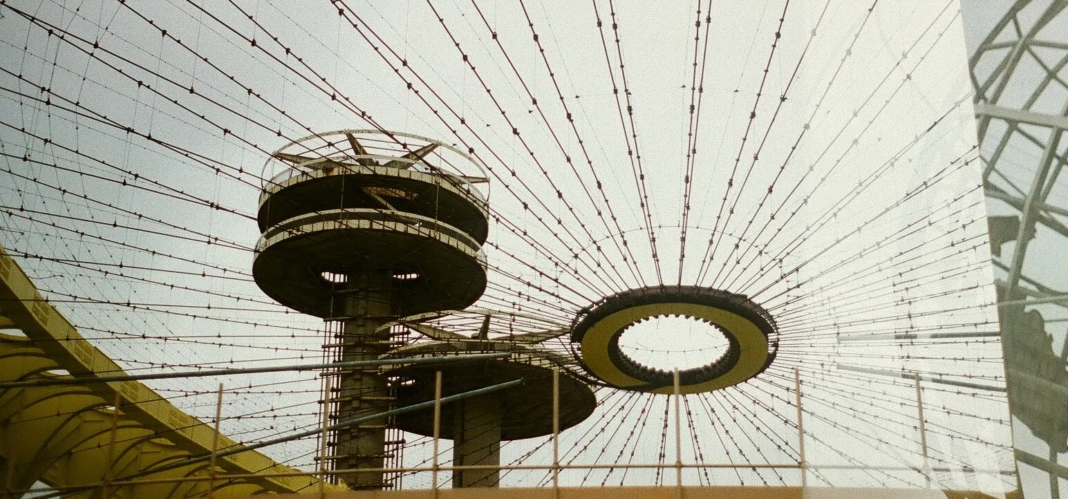 Looking up at the spoked ceiling structure of a modernist building